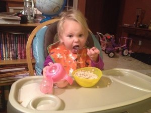 Learning to use a spoon to eat cereal like a big kid!