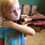 Rachel learning how to position her fiddle