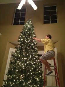 Bryan putting up our huge tree!  He is very brave!