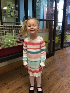 Sarah at daycare on her birthday. She is posing with the pet guinea pig :)